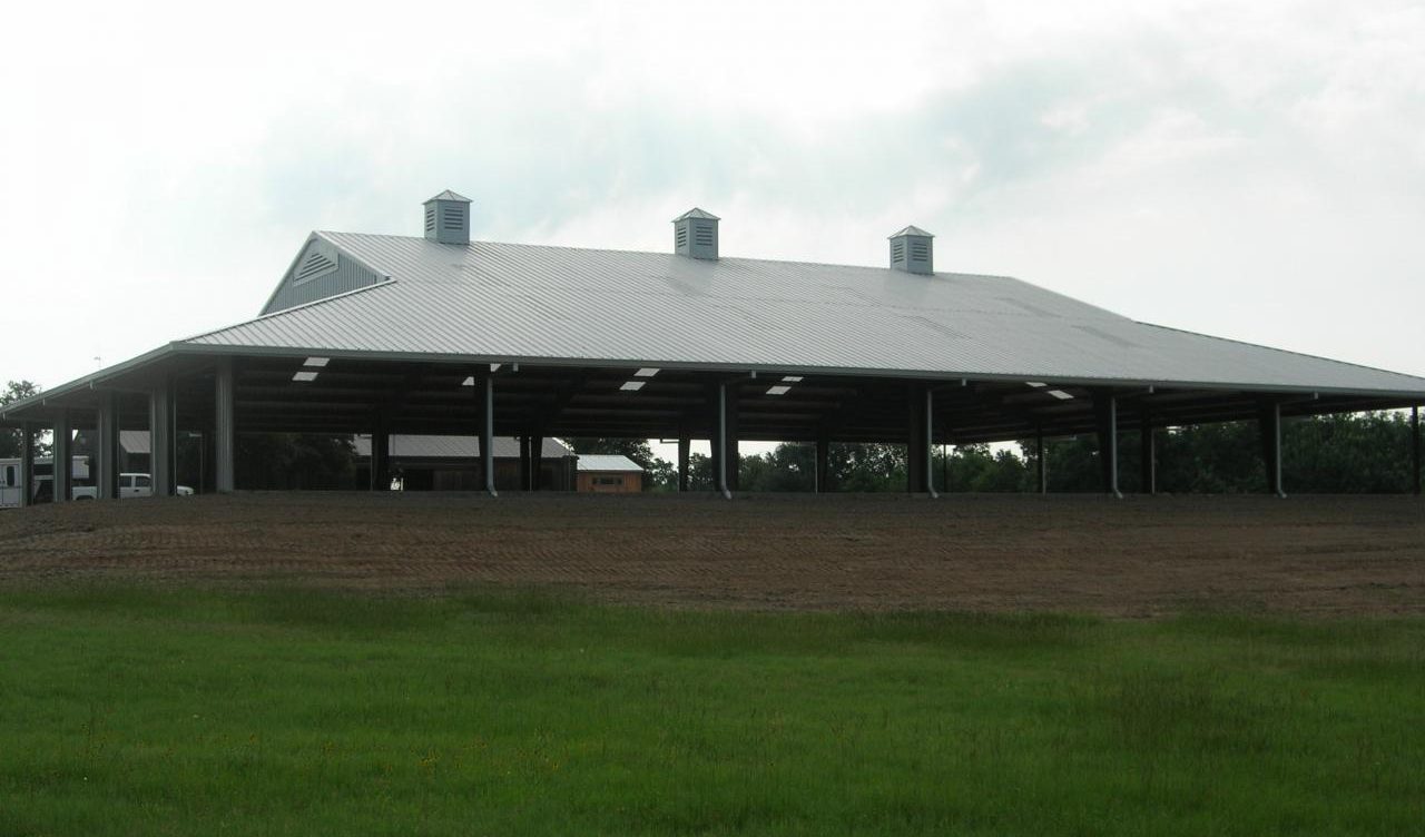 Covered riding arena on open ranch land