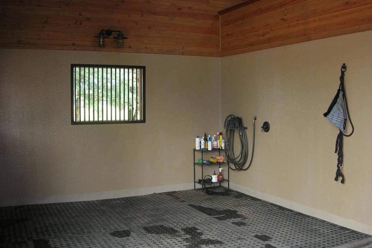 Wash bay with wood-paneled walls inside Cypress Stable